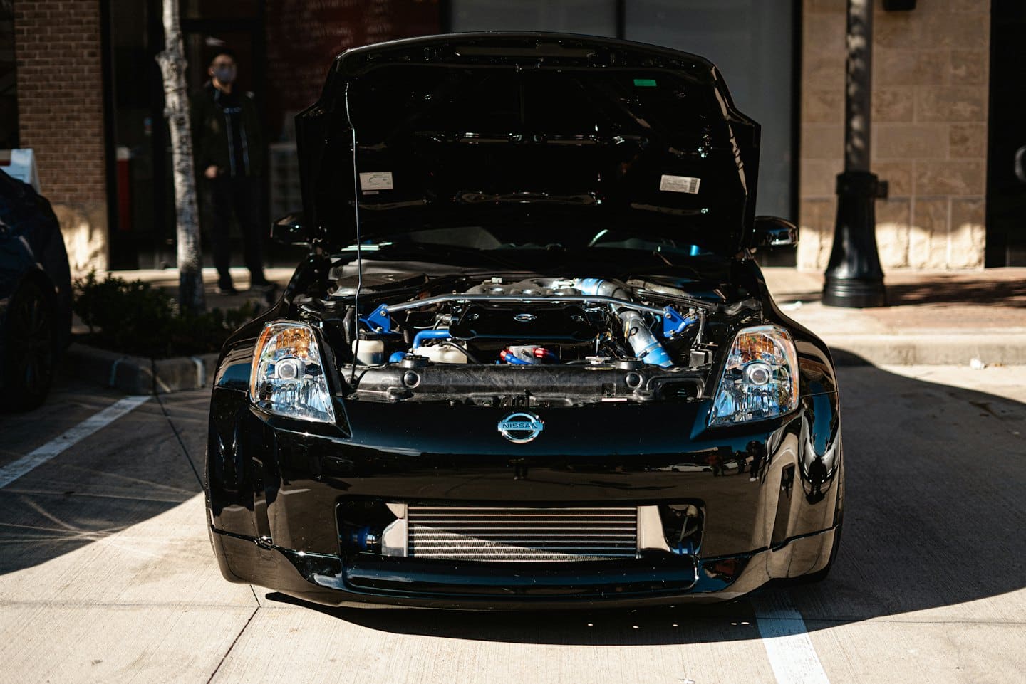 Customized sports car engine bay with blue parts.